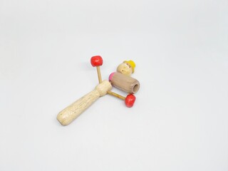 Wooden toy rattle on a white background. This image is perfect for illustrating concepts like childhood, play, and early development. It's a simple, clean shot.
