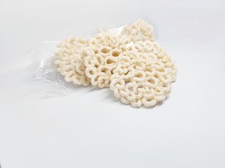 Stack of Indonesian crackers on a white background. These crispy, airy snacks are a popular appetizer or side dish, perfect for various culinary applications.