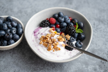 Fruit and berry yogurt bowl with granola, summer forest berries. Clean eating diet