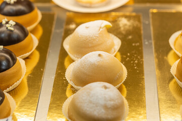 Assorted gourmet pastries displayed on a golden tray showcasing delightful textures and flavors