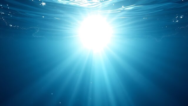 Sunlight streams through ocean waves, creating a mesmerizing play of light and shadow in deep blue waters.