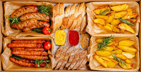 Savoring a delicious meal with assorted sausages, bread, and golden potatoes