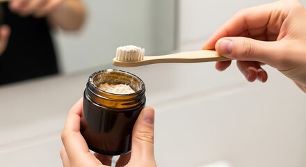 Applying natural toothpaste powder with a bamboo toothbrush