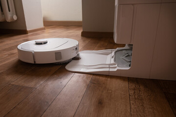 Task done the robot vacuum returns smoothly to its home base to recharge batteries and empty the dustbin without human help.
