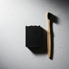 Black charcoal soap bar with a bamboo toothbrush