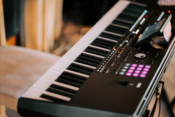 Fototapeta premium Music creation during a studio session with a synthesizer and keyboard