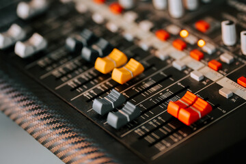Controls of a professional mixing console in a recording studio environment