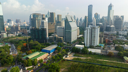 Naklejka premium Aerial view modern office city building green tree park Lumpini public park downtown