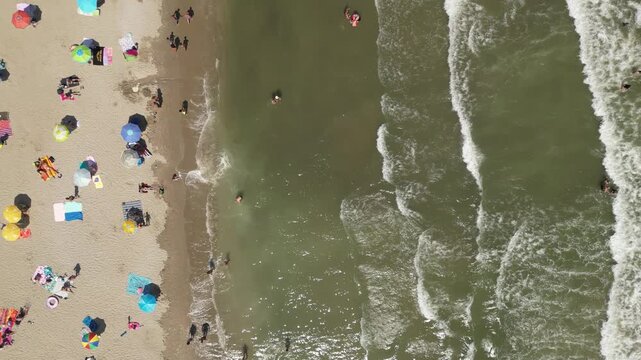 Aerial Shot of Waves Crashing and Tourists Enjoying Adriatic Sea &ndash; Summer Beach Life in Rimini Emilia-Romagna Italy &ndash; Original Footage