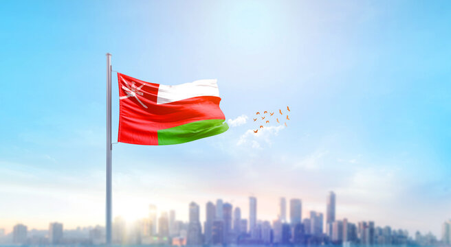 Oman national flag waving with skyline and buildings. Oman national flag for independence day.