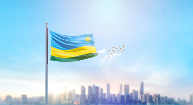 Rwanda national flag waving with skyline and buildings. Rwanda national flag for independence day. - Powered by Adobe