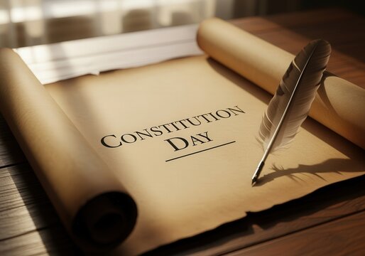 Constitution day scroll with quill on wooden table in sunlight