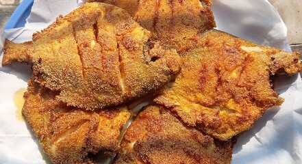 Crispy fired Pomfret fish, Indian seafood. marinated with garlic, lemon and spices, then coated...
