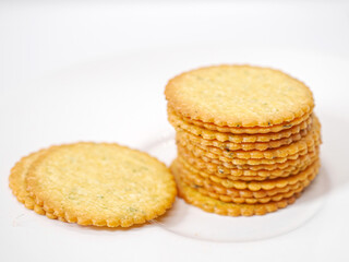 Thin round biscuits crackers stacked together close-up, Sweet and tasty round butter crackers.