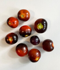 Nine tomatoes on a white background.