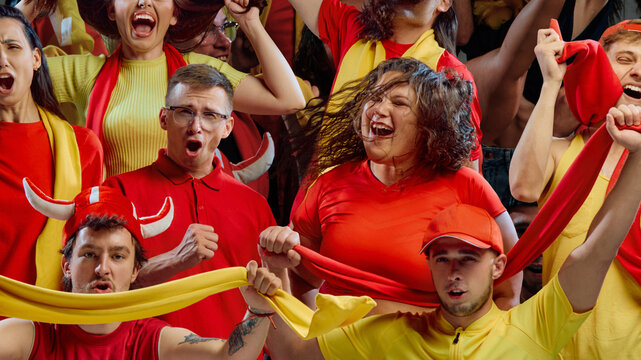 Female plus size fan in red shirt cheering with group of supporters in stadium. Concept of sports brands, women leadership, live event marketing, culture of support.