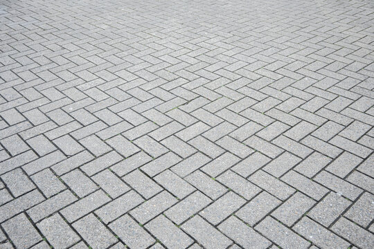 Stone wall with much gray bricks of the modern building.