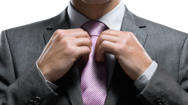 Man adjusting his pink tie while wearing a formal suit, isolated on white background.