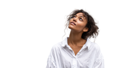 Young woman looking up with curiosity, wearing a white shirt against a transparent background.