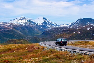 Car driving through Norwegian mountains and landscape, Panorama Road Tindevegen, Norway