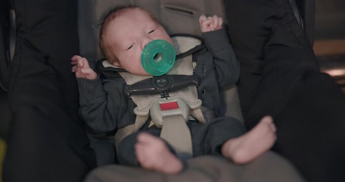 New Born Preemie Sucking Passie In Car Seat