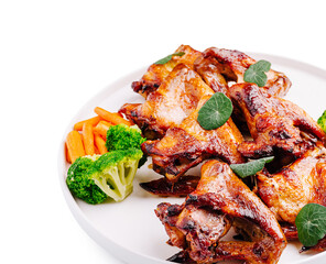 Deliciously grilled chicken wings served with fresh vegetables