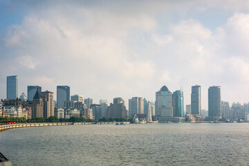 Fototapeta premium Panoramic view of modern city skyline with river in foreground