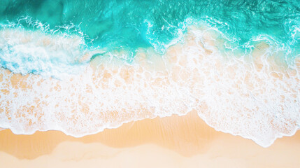 Aerial view of a sandy beach with turquoise waves crashing onto the shore.