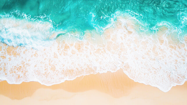 Aerial view of a sandy beach with turquoise waves crashing onto the shore.