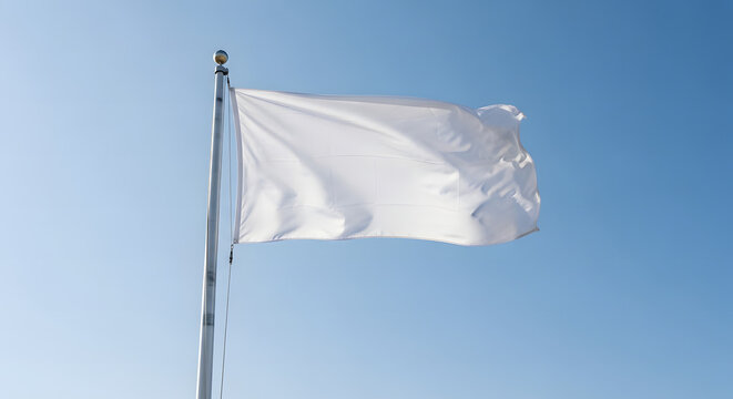 A blank white flag flutters on a silver flagpole against a clear, bright blue sky.
