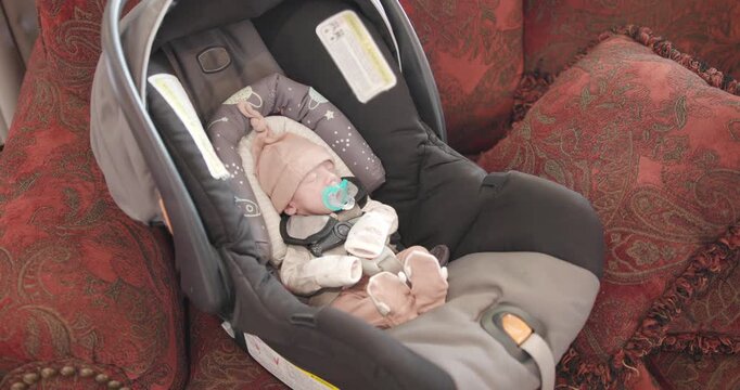 Small New Born Baby Sucking Paci in Car Seat