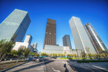 Modern Urban Skyline: A Majestic Symphony of Glass and Steel Under Clear Blue Skies