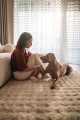 Cozy Moments A Woman Enjoying Special Bonding Time with Her Dog at Home
