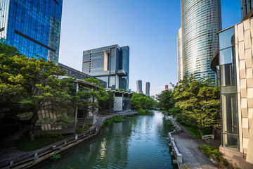 Captivating Urban Landscape with Lush Greenery and Serene Waterway Reflections