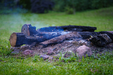 half-extinguished campfire after outdoor activities © talavietis
