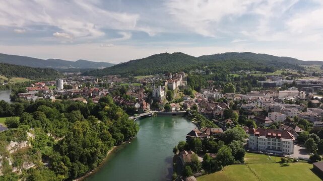 The city of Aarburg with the Aare River flowing through it from an aerial perspective. A historic city in the Bezirk Zofingen district on a sunny day
