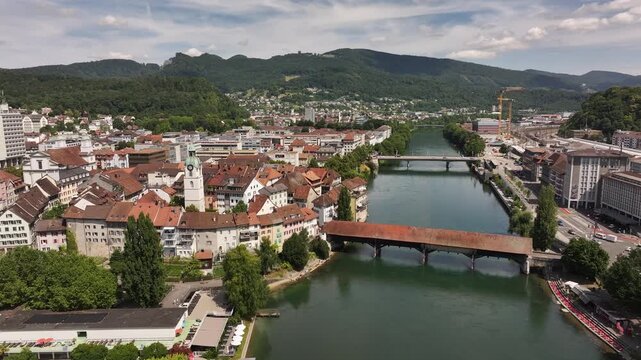 aerial - historic covered bridge crosses river aare in central olten solothurn switzerland