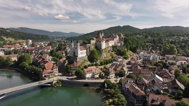 aerial - aarburg castle and church rise above the aare river in solothurn switzerland summer
