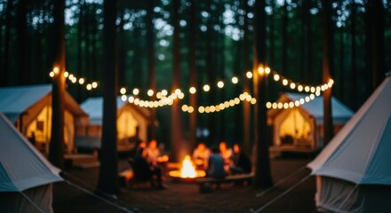outdoor evening gathering at a glamping site with campfire and tents