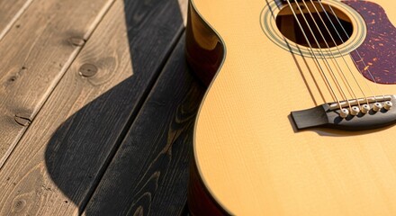 Naklejka premium Acoustic Guitar Close-Up on Wood Planks, Capturing the Beauty of Music and Craftsmanship in Natural Light