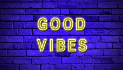 Neon sign with the words "good vibes" on a brick wall.