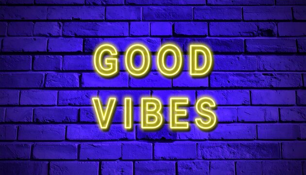 Neon sign with the words "good vibes" on a brick wall.