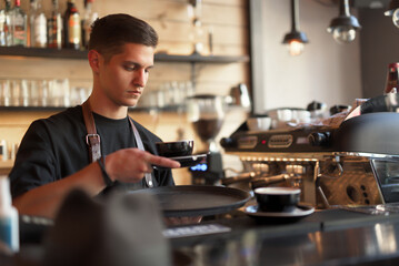 Barista Preparing Coffee in a Cozy Café With Professional Equipment