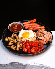 Fried egg on toast with sausages beans mushrooms and cherry tomatoes. Perfect full English-style breakfast for cafes menus advertising