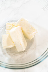 Softened Butter Cubes in Glass Mixing Bowl