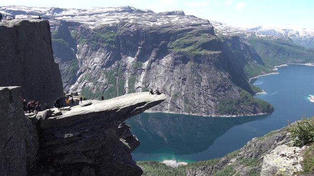 Stand on the iconic Trolltunga, a breathtaking rock formation jutting out over a stunning Norwegian fjord, offering unforgettable views.