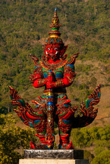 Red Thai Yak statue protecting the place 