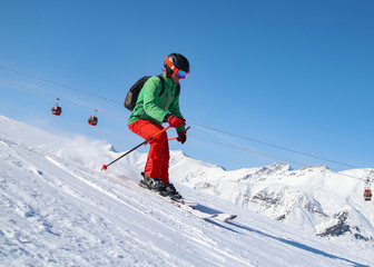 athletic man skiing skillfully at ski resort in mountains