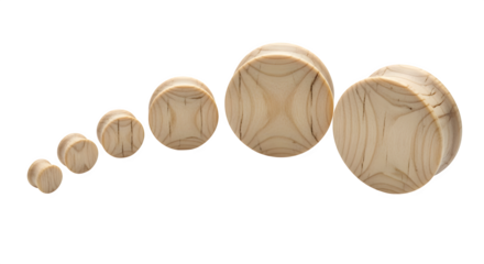 Stretched ear plugs in wood texture, isolated on white background