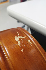 Real wood armrests that are damaged from use.